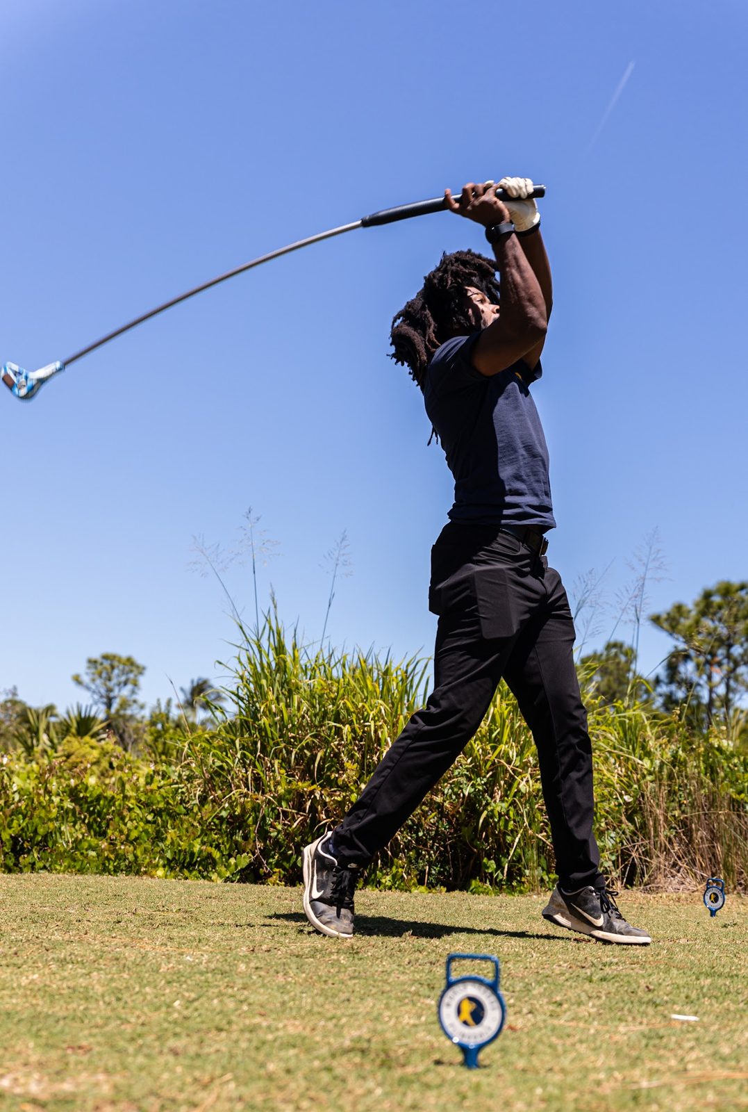 Garry Callis Jr. holding a FlingStick on the course
